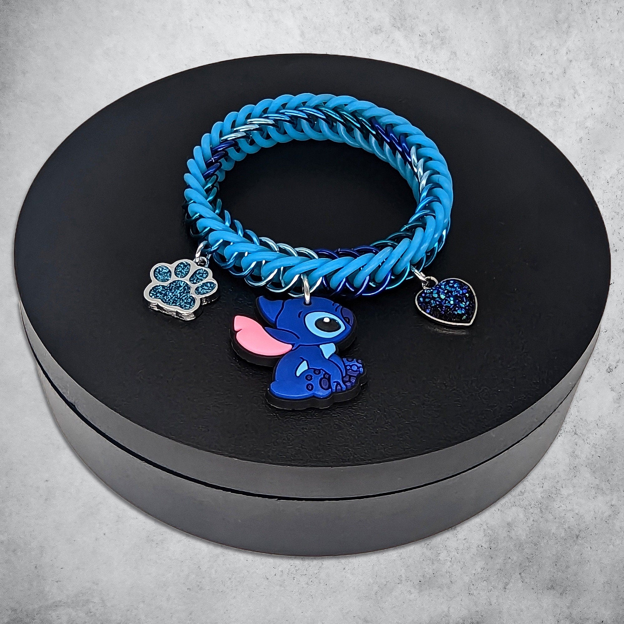 Blue Alien Charm Bracelet Place in Black Stand Side View